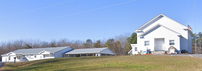 A white building in a field

AI-generated content may be incorrect.