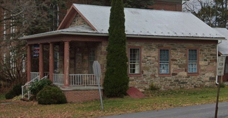 A house with a sign on the side of the road

AI-generated content may be incorrect.