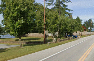 A road with trees and a telephone pole
AI-generated content may be incorrect.