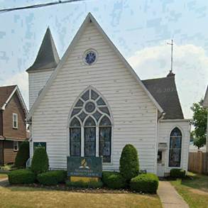 A white church with a blue clock on the front

AI-generated content may be incorrect.